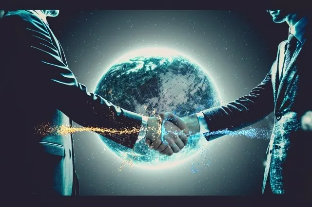 宇宙空間にある地球をバックに2人のビジネスマンが握手する様子